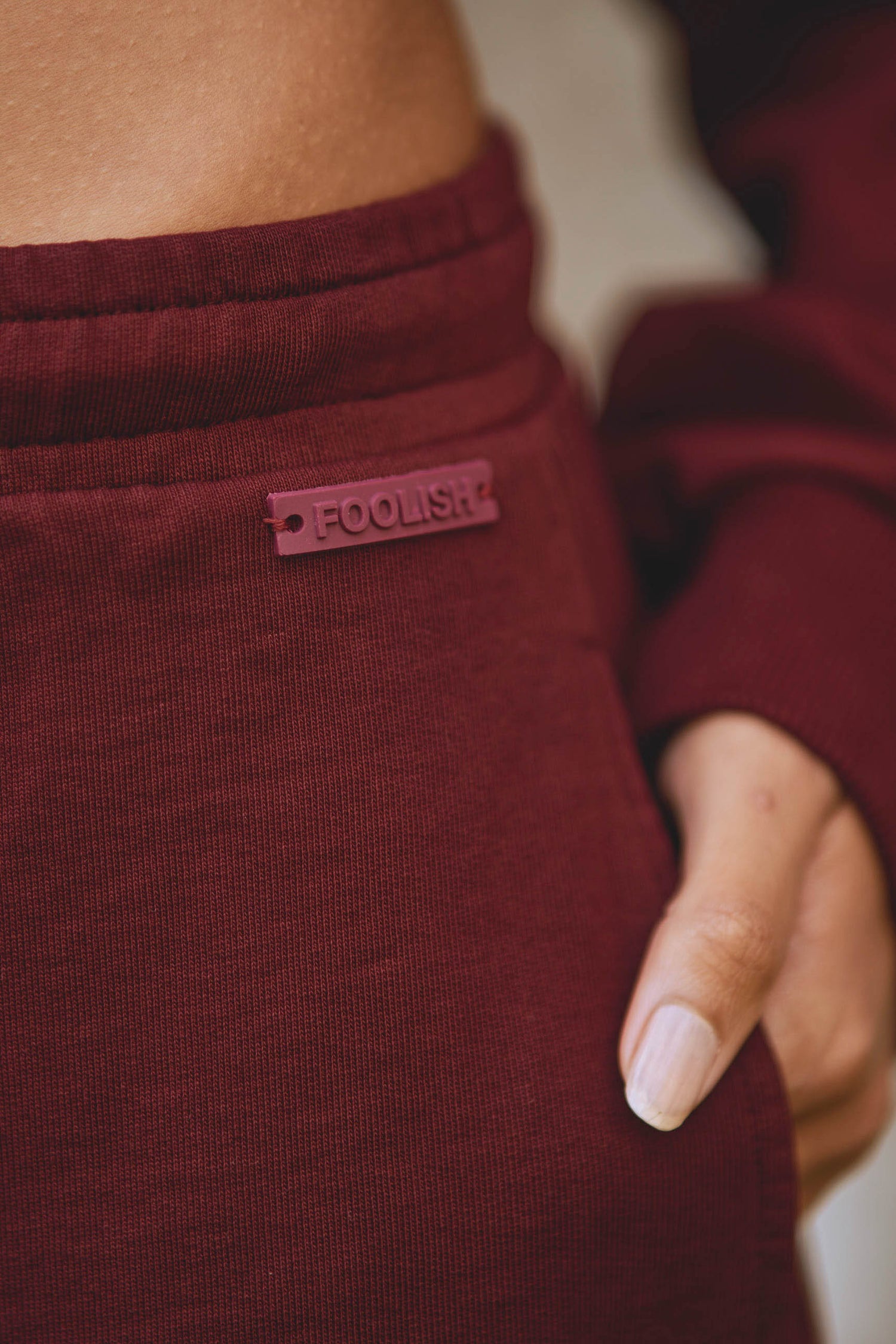 close up of detail on core joggers in burgundy
