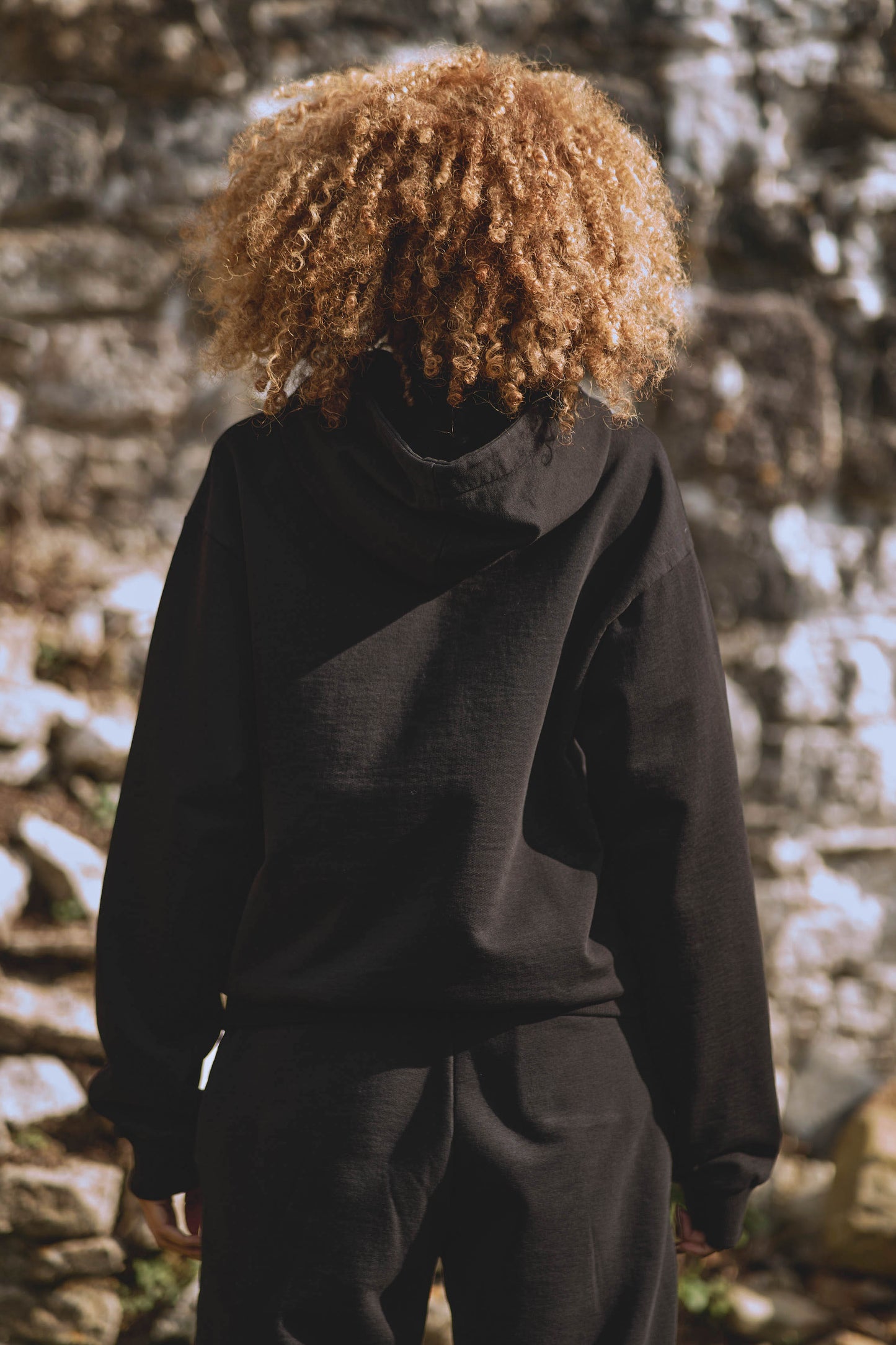 back view of womens luxury tracksuit in black