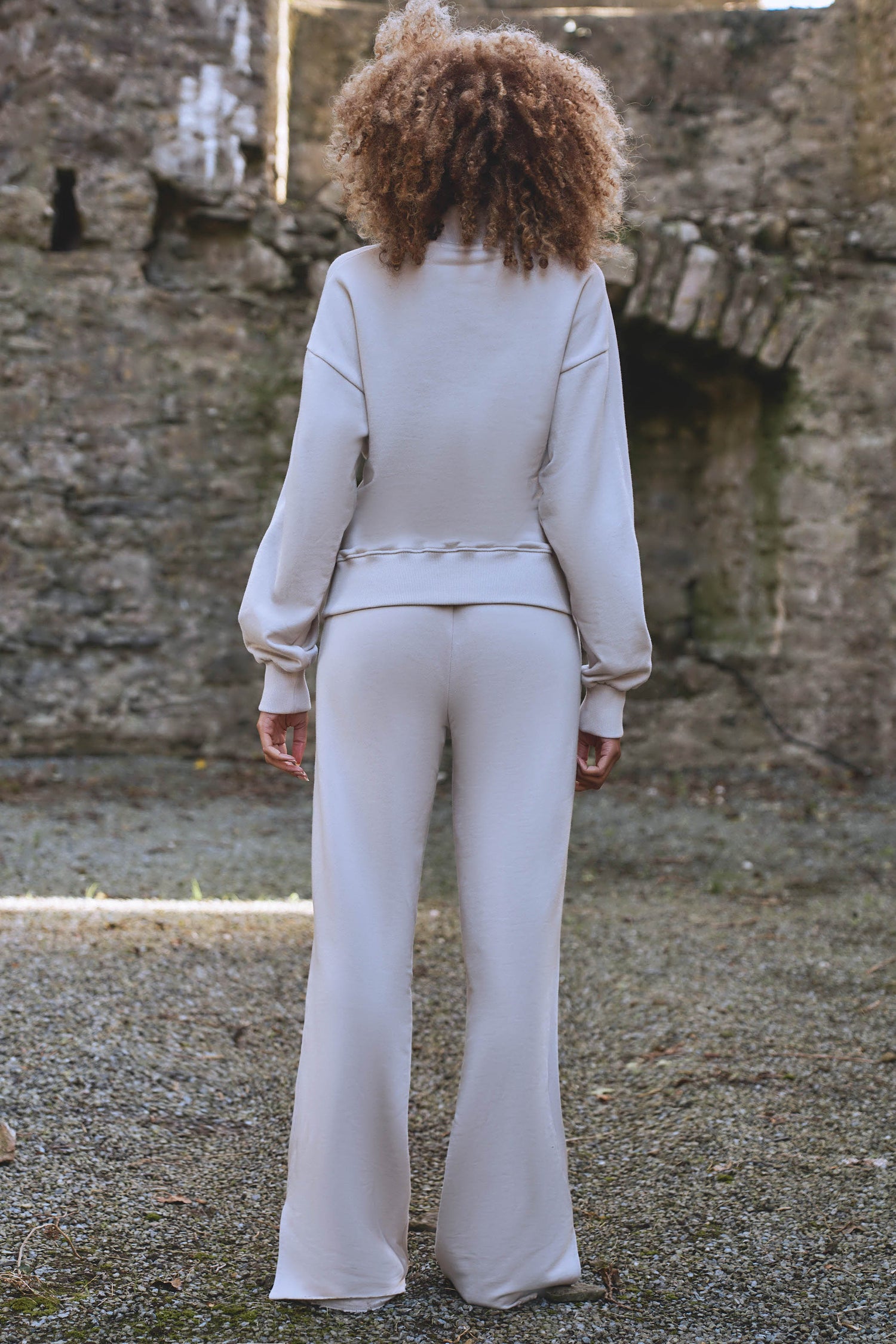 back view of luxury womens tracksuit in cream
