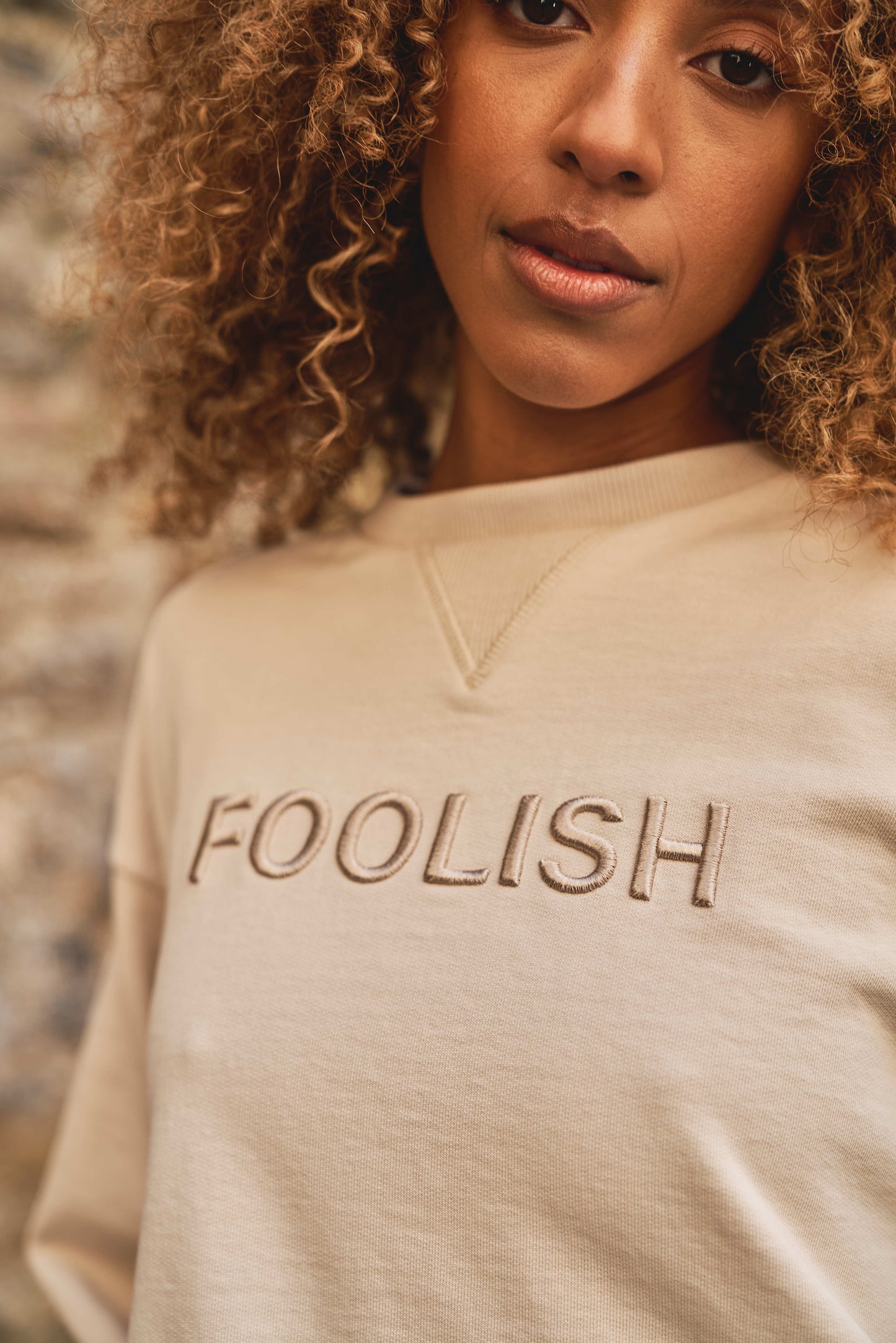close up of model in luxury womens sweatshirt in the colour cream