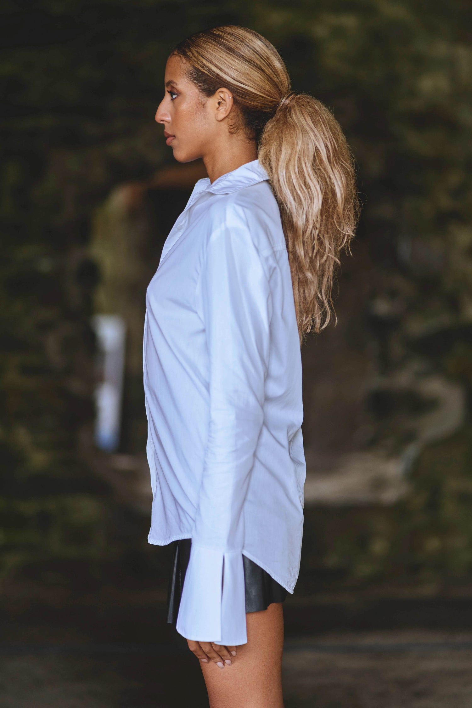 side view of model wearing luxury white shirt with large cuffs 