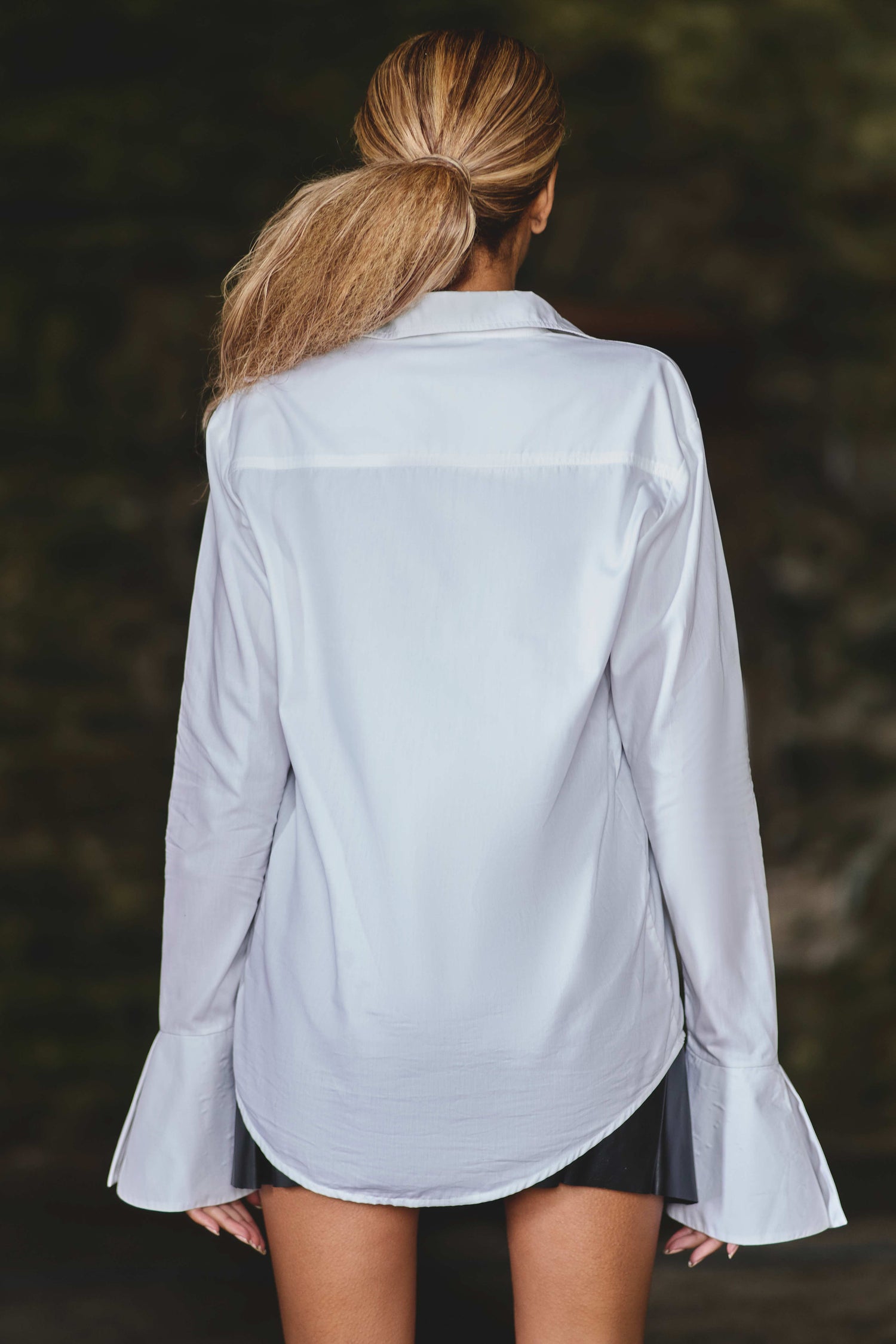 back view of model wearing luxury white shirt with large cuffs