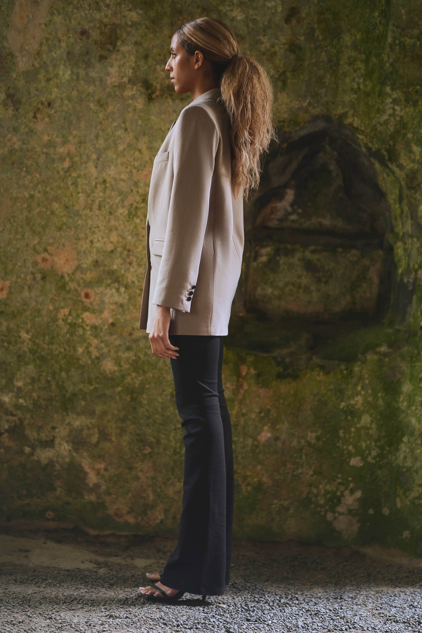 side view of womens classic blazer in camel with black pants