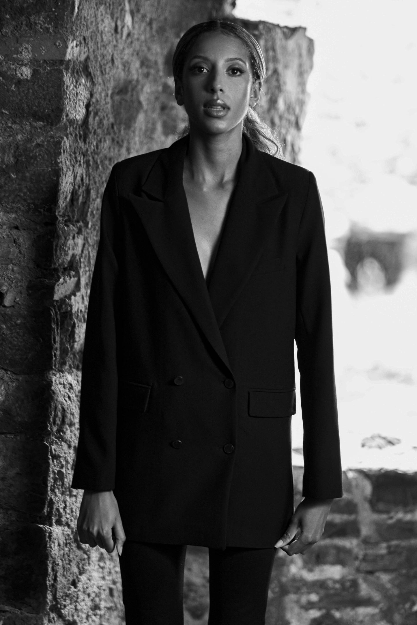 image of model wearing womens black luxury blazer