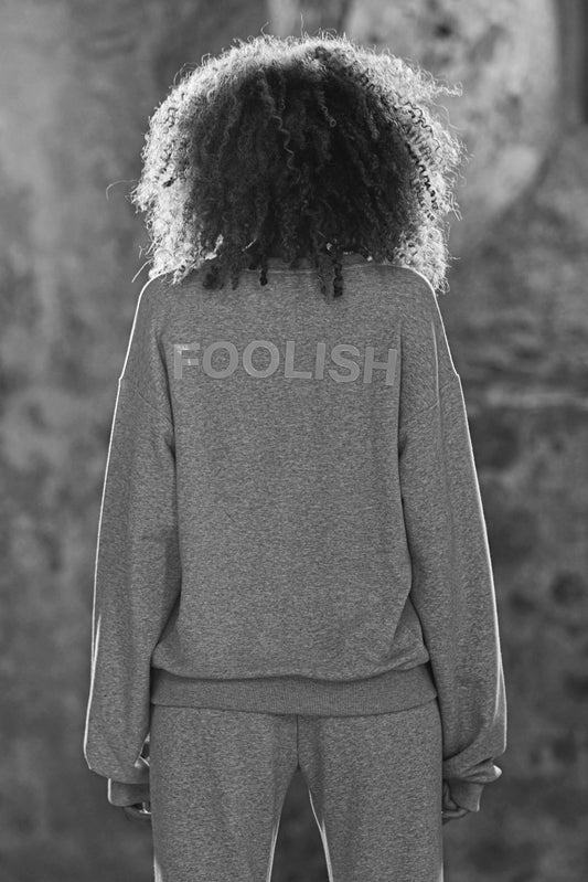 image showing back of model in grey luxury sweatshirt with branded detailing