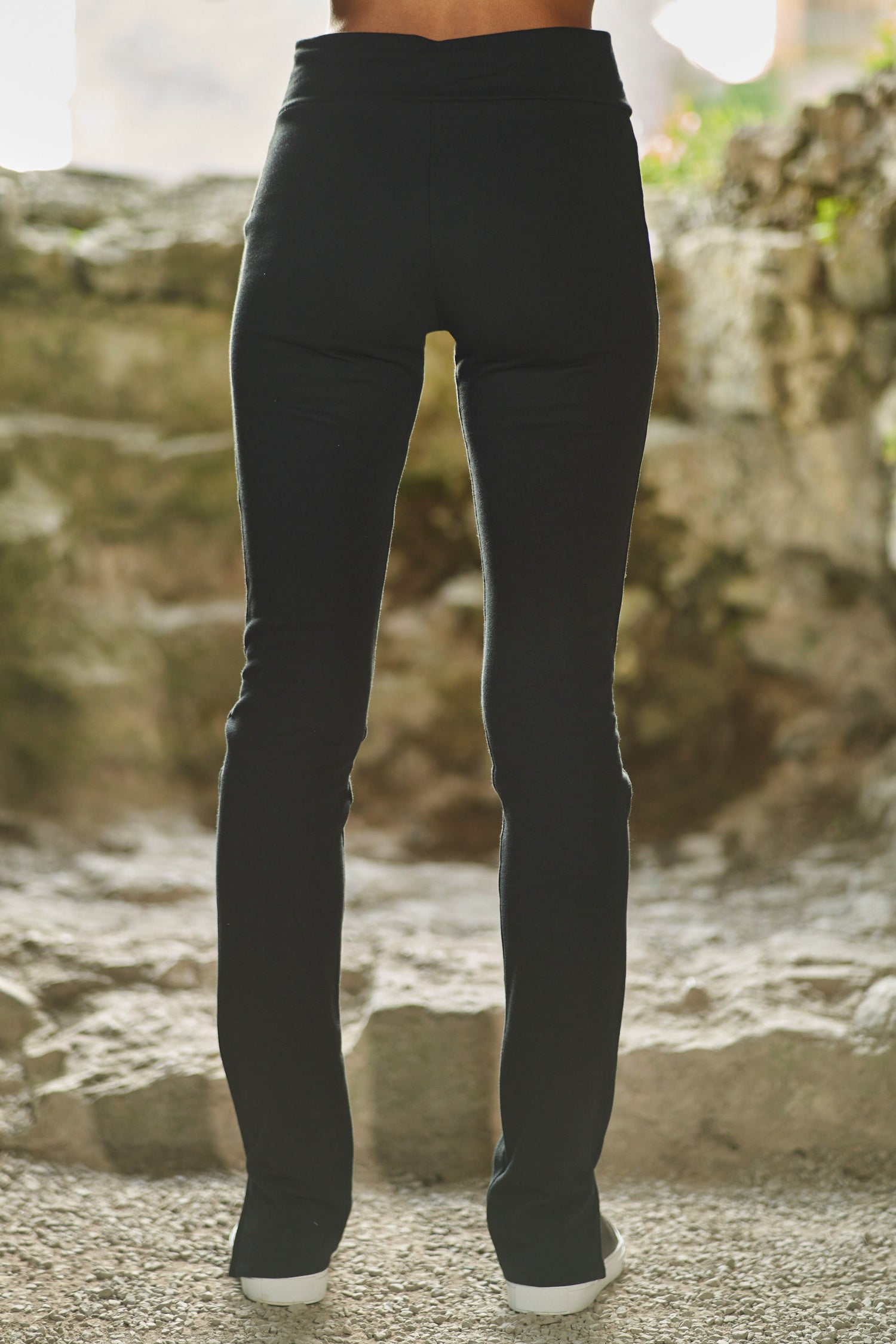 back view of model wearing womens luxury split hem pants in black