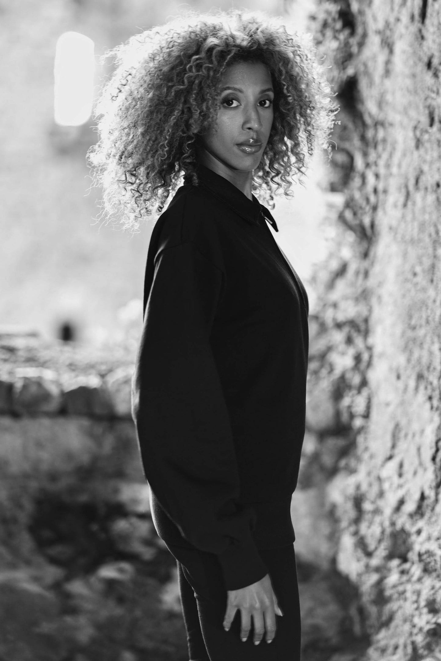side image of model wearing athleisure sweatshirt in black