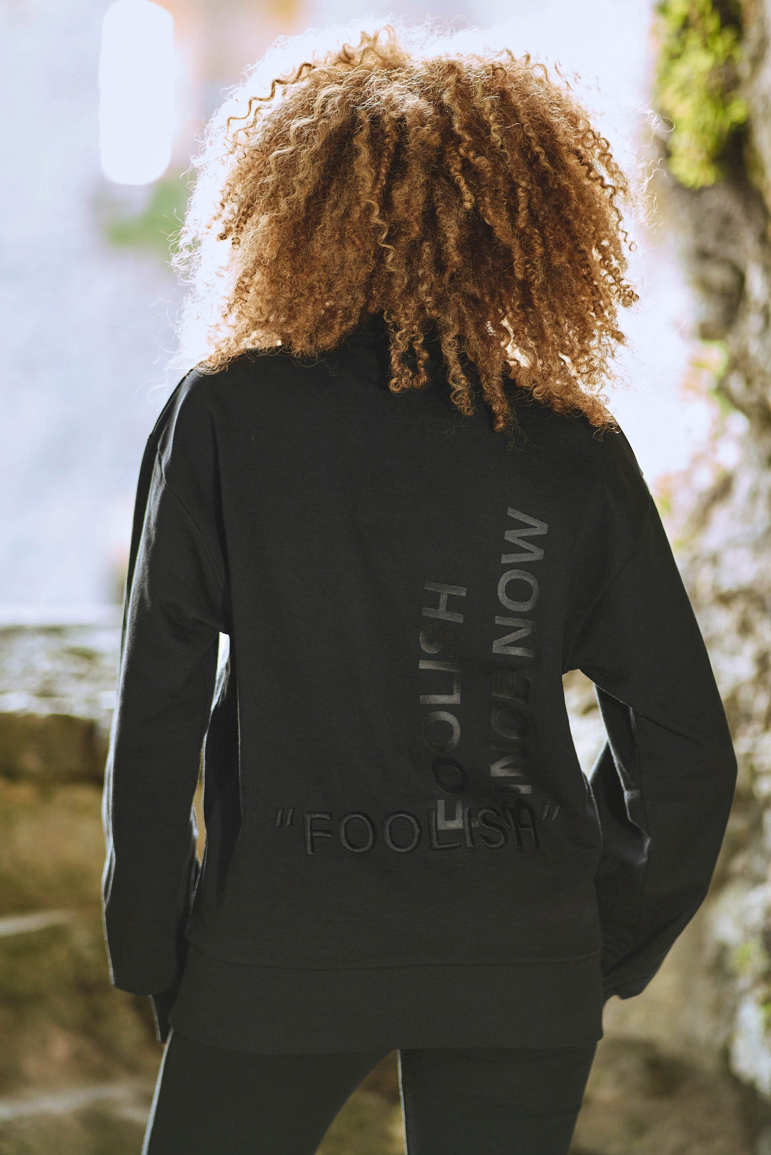 image of back of model wearing luxury womens sweatshirt in black
