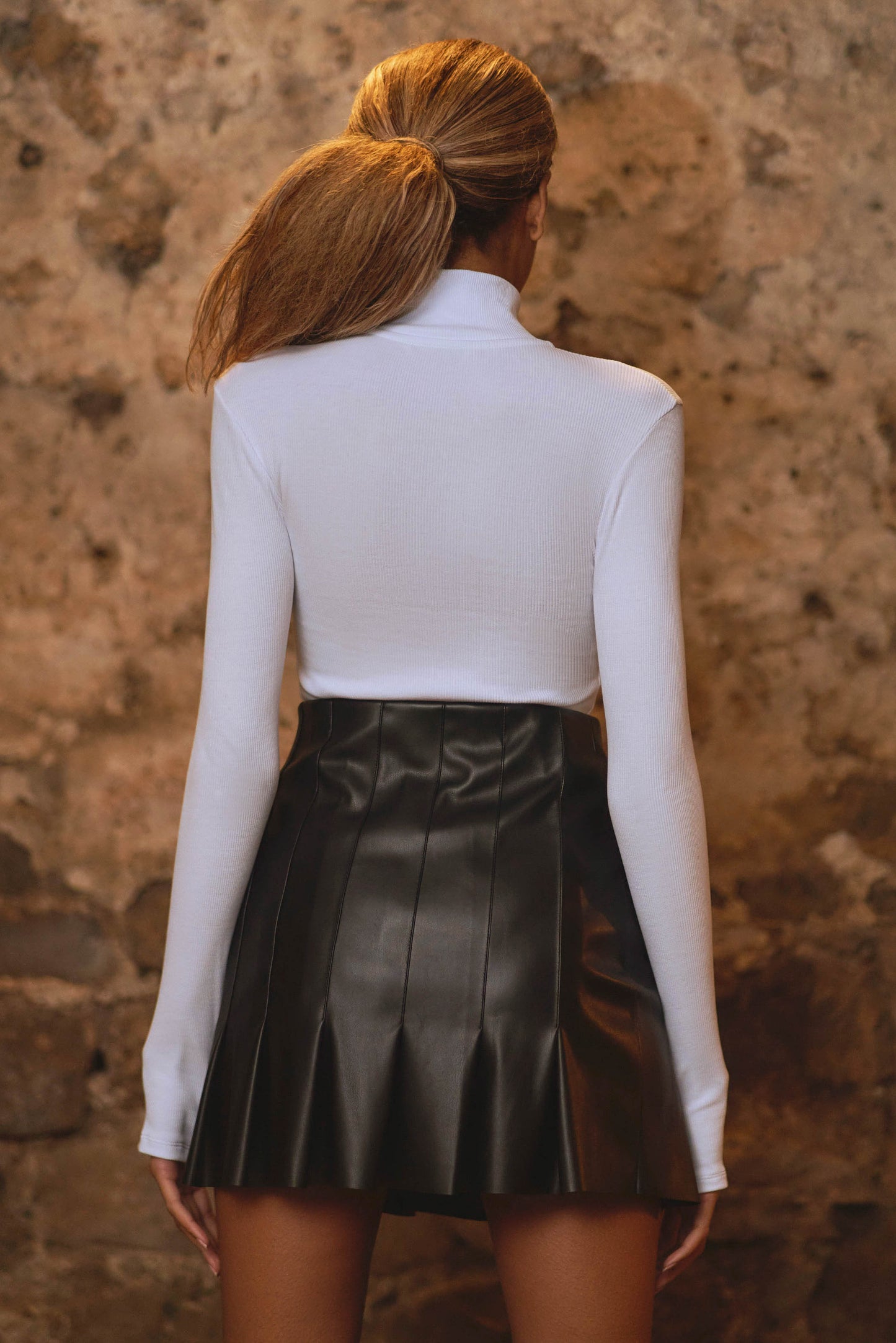 back view of womens luxury bodysuit in white