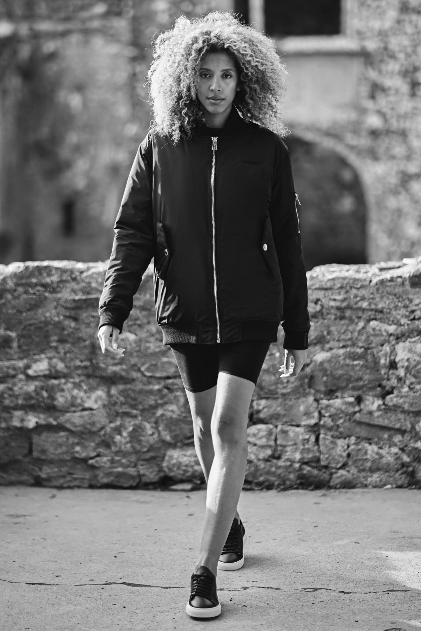 model walking towards camera in luxury bomber jacket