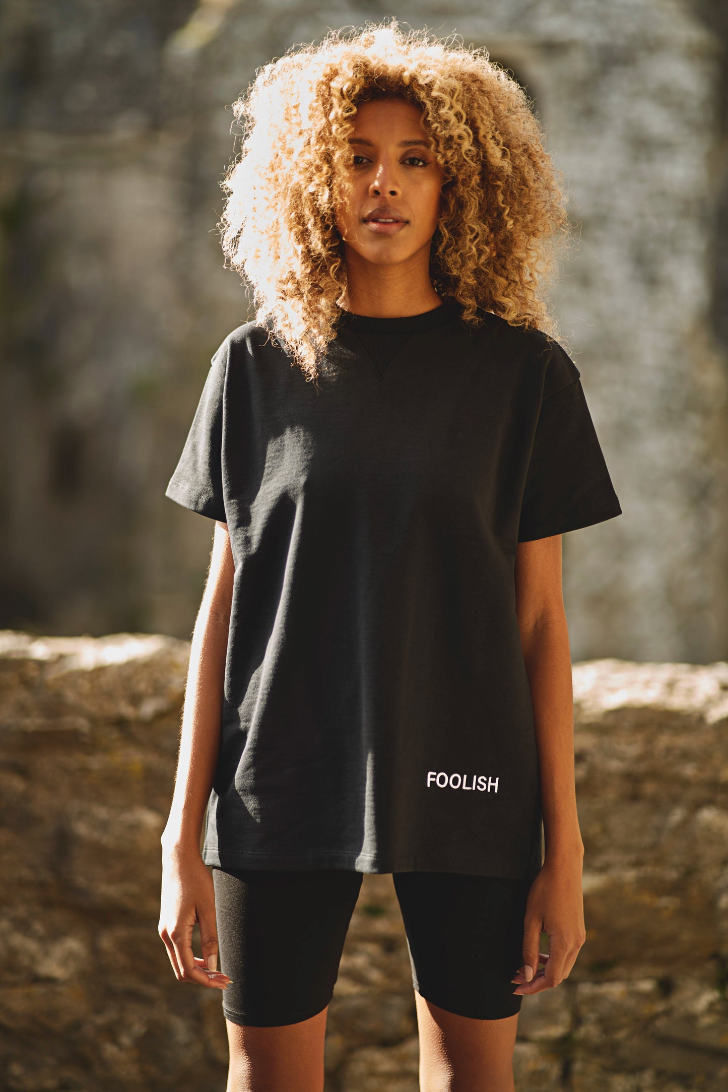 front view of model wearing black luxury womens t-shirt with shorts