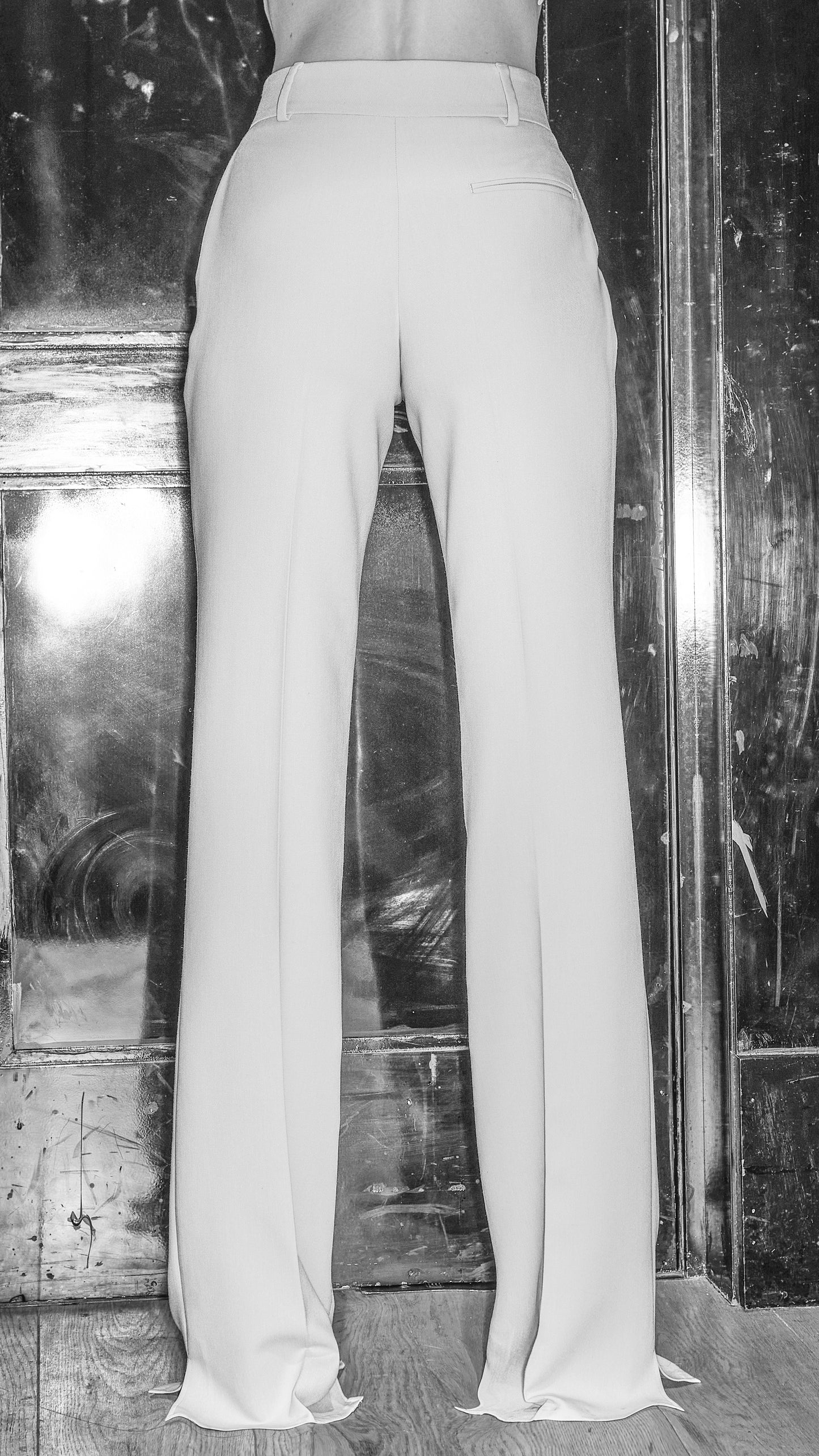 model posing to show back of womens stone trousers