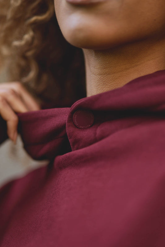 close up detail on womens luxury burgundy hoodie