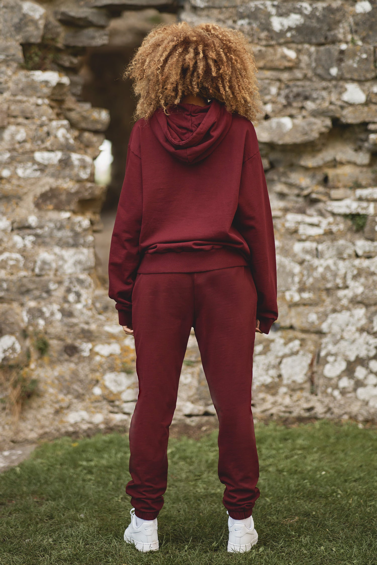 full back view of luxury womens core tracksuit in burgundy