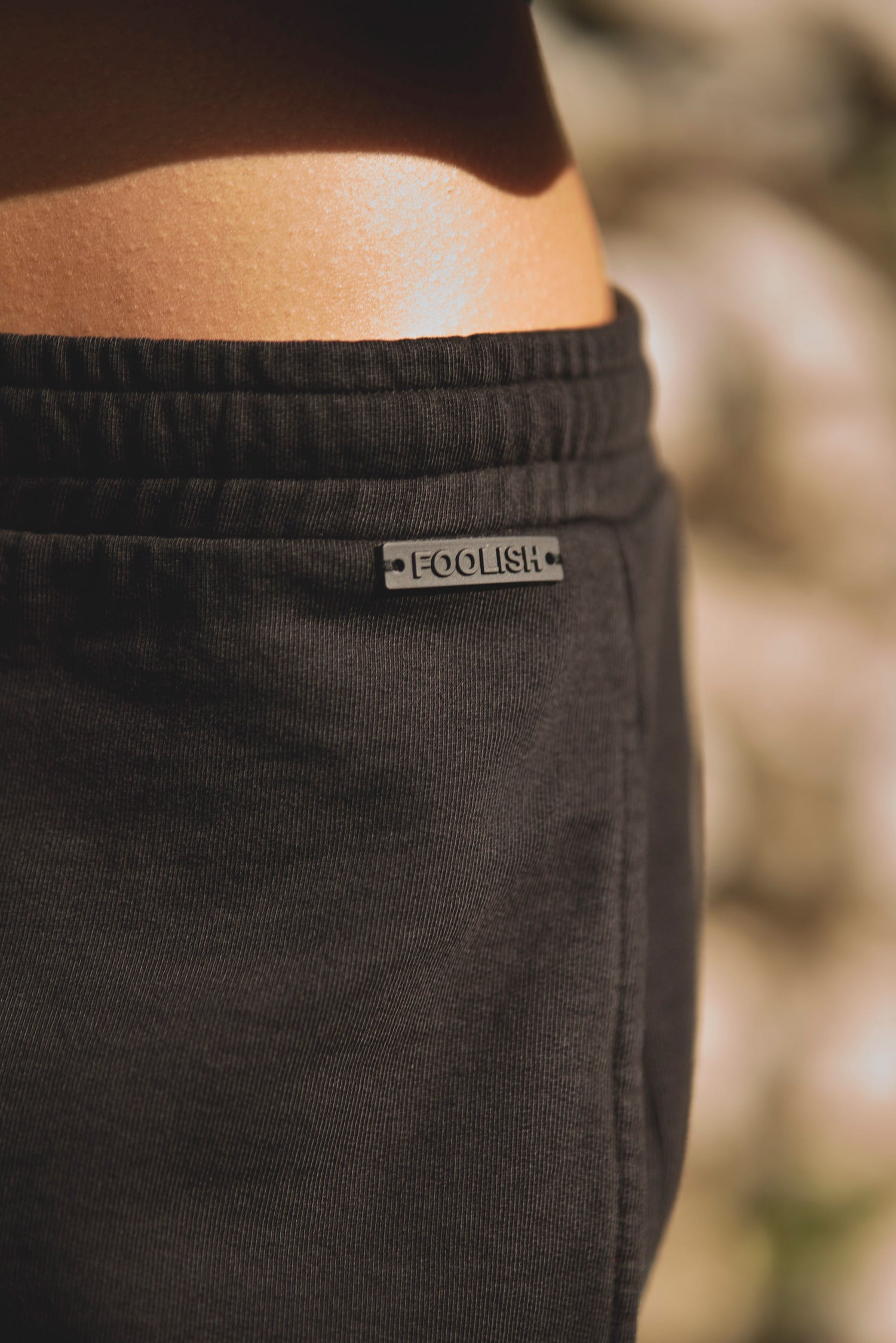 close up detail on womens luxury black joggers