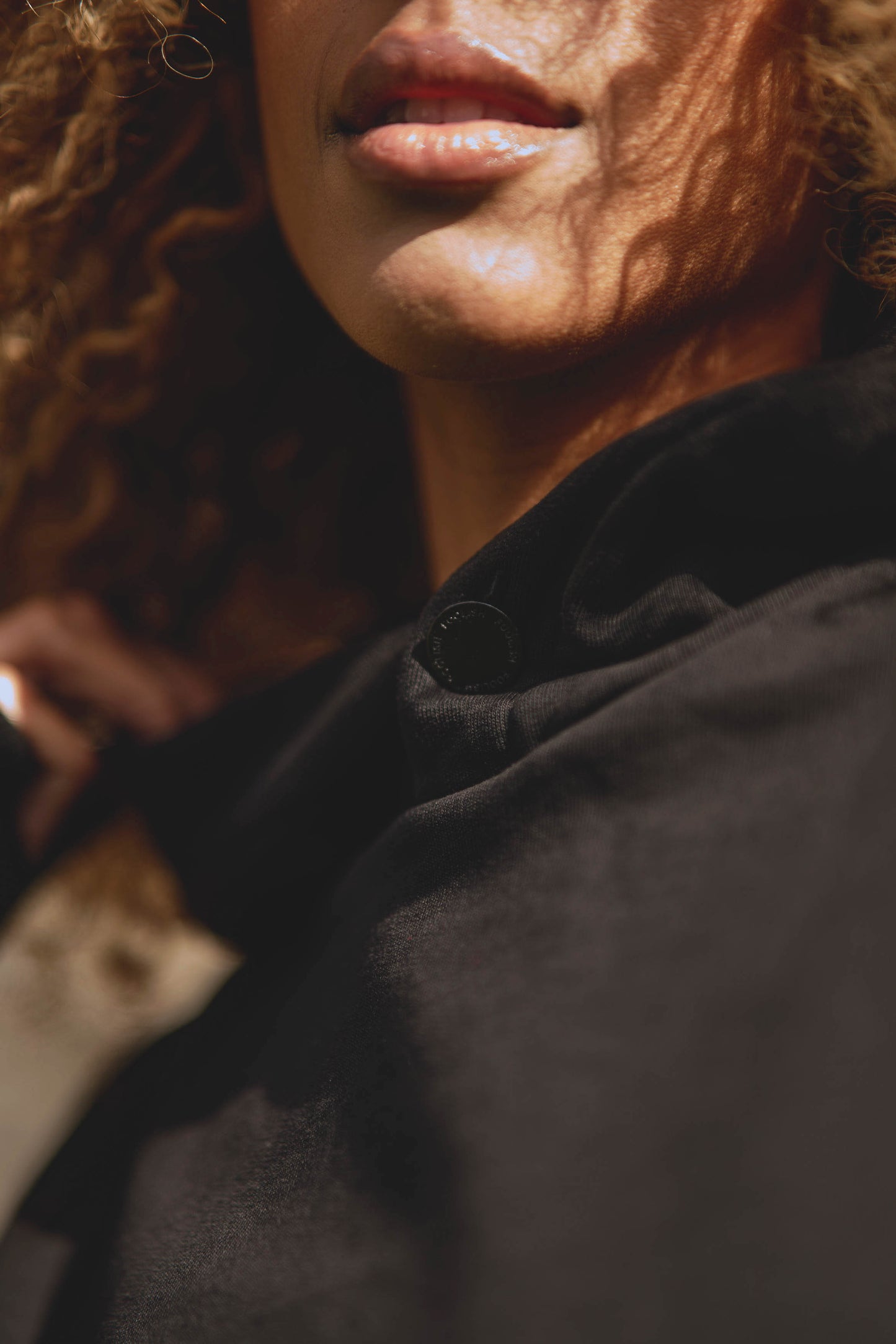 close up detail of womens luxury hoodie in black