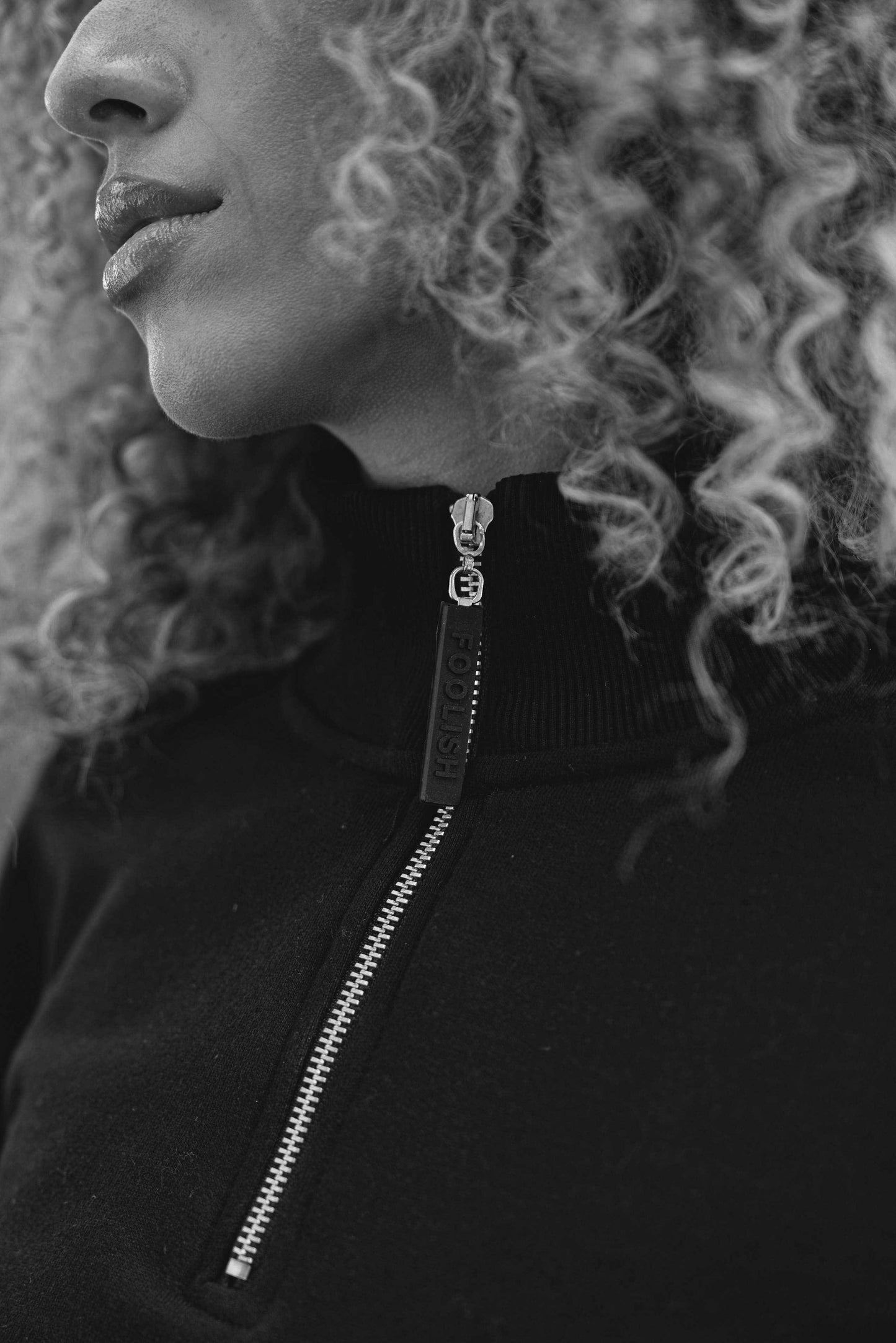 close up of zip detail on luxury womens track sweatshirt in black