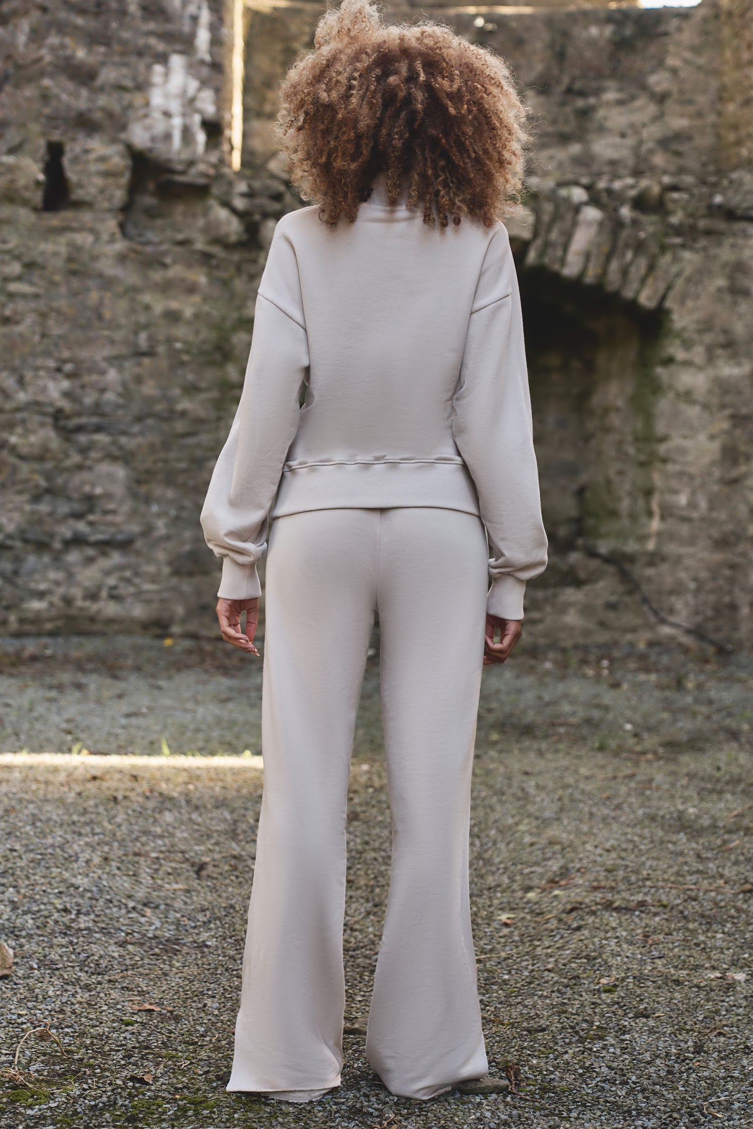 full back view of luxury womens tracksuit in cream