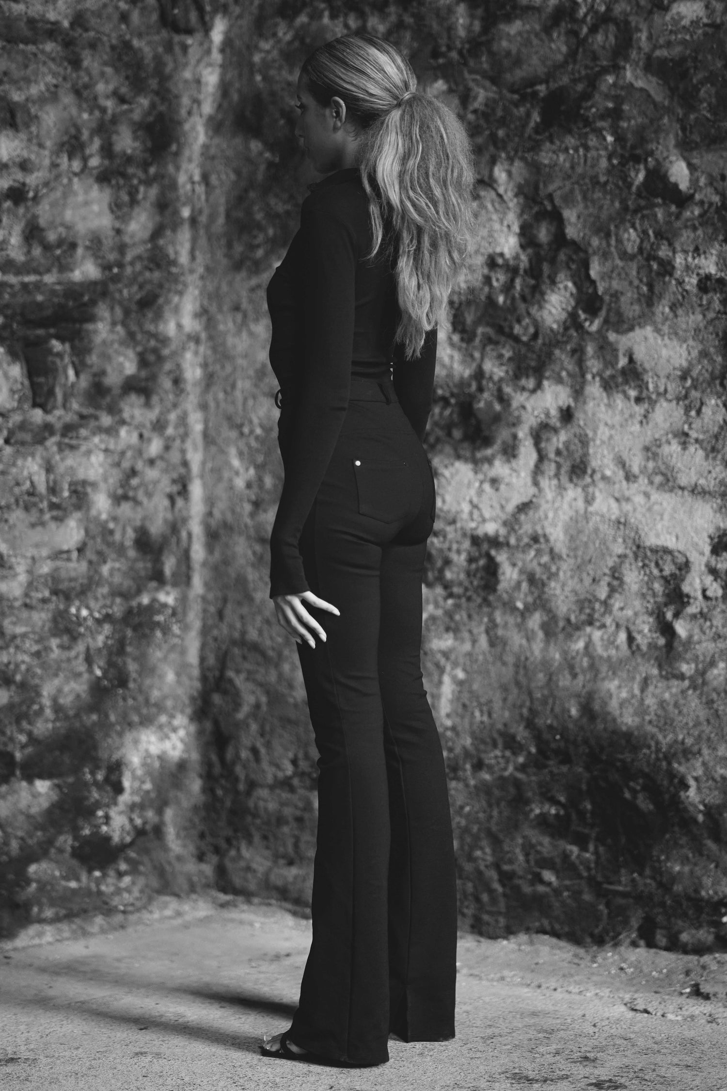 side view of womens luxury bodysuit with long sleeves in black