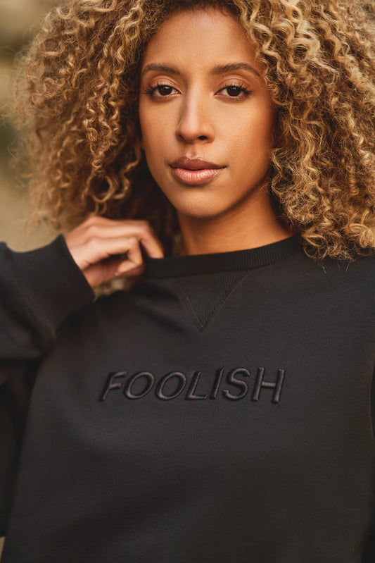 close up of branding on organic cotton sweatshirt in black