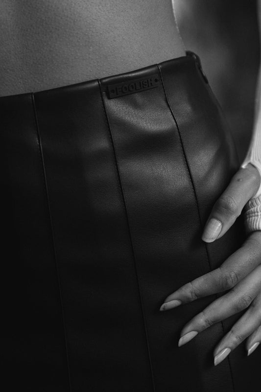 close up detail of branding on womens luxury leather skirt in black