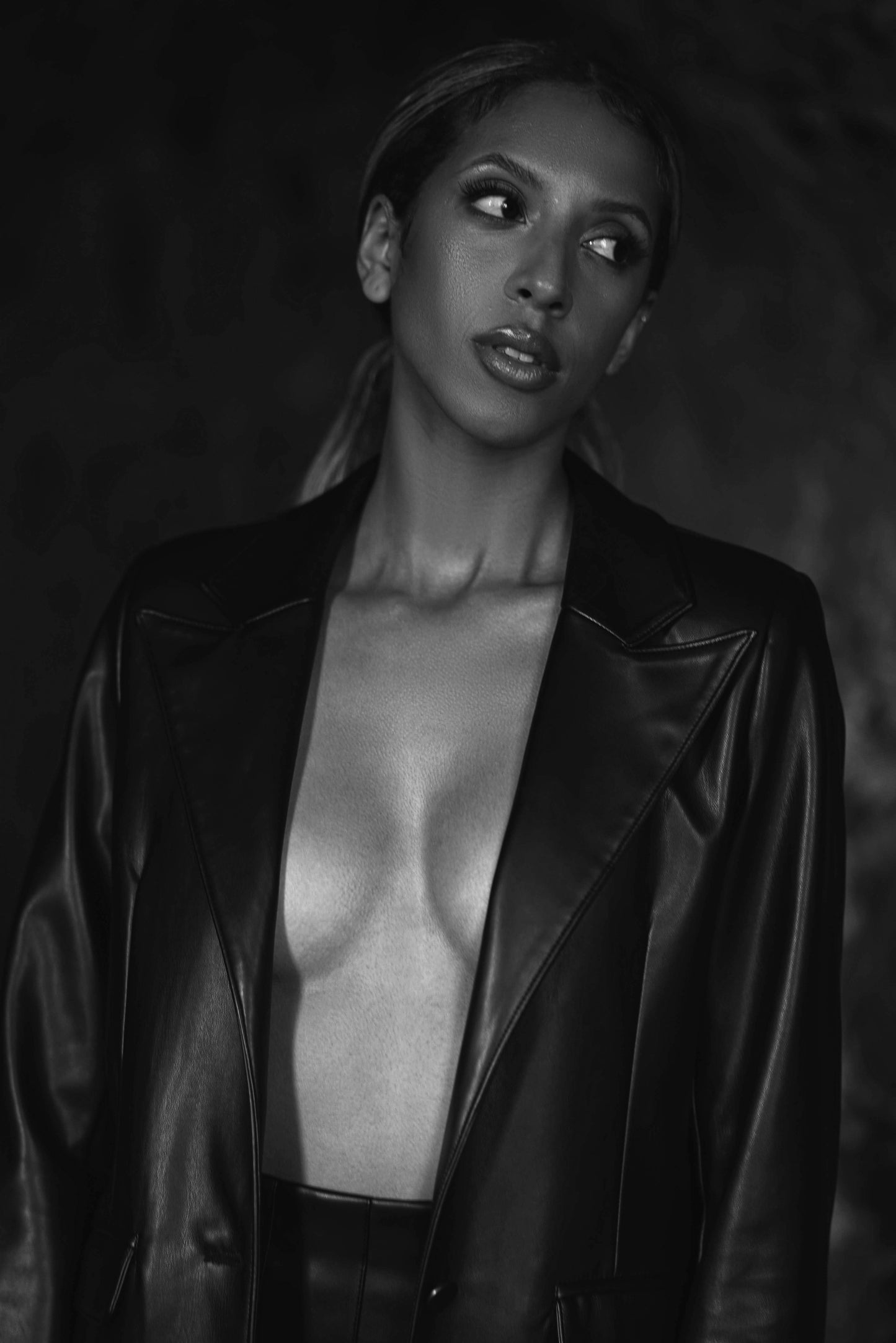 close up of model wearing statement vegan leather blazer in black