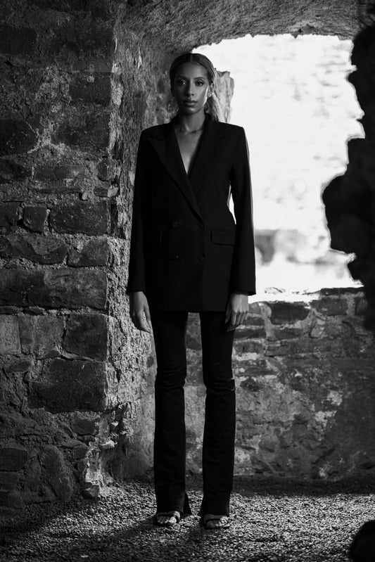 black and white image of womens luxury blazer and trousers in black