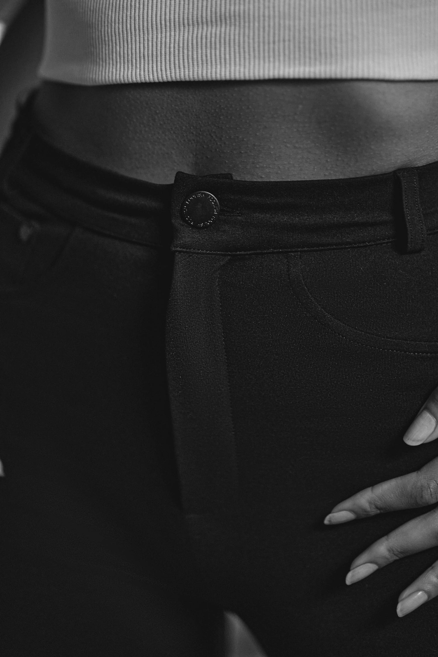 close up of button detail on luxury black flared pants