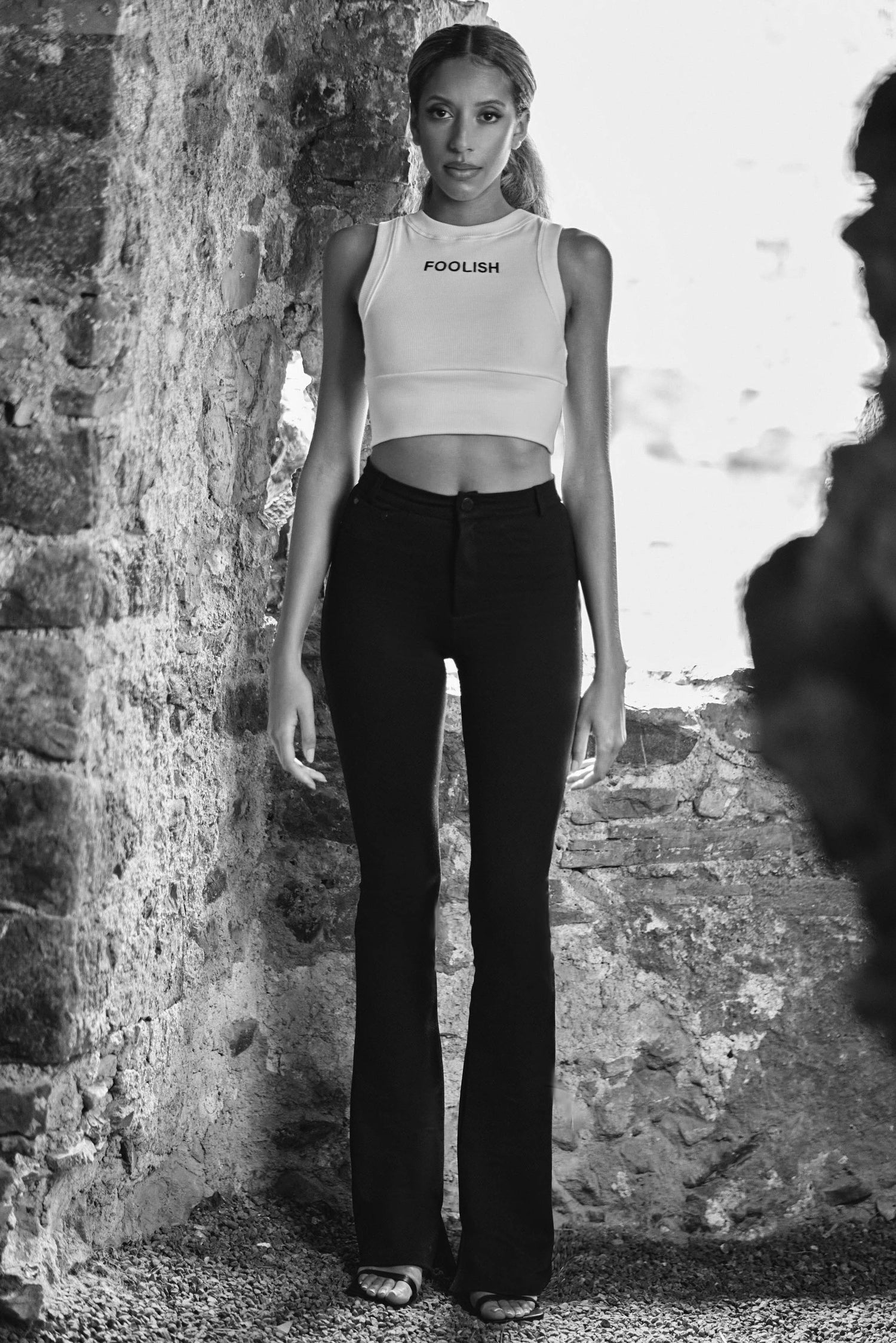 front view of luxury womens crop top in white with black pants