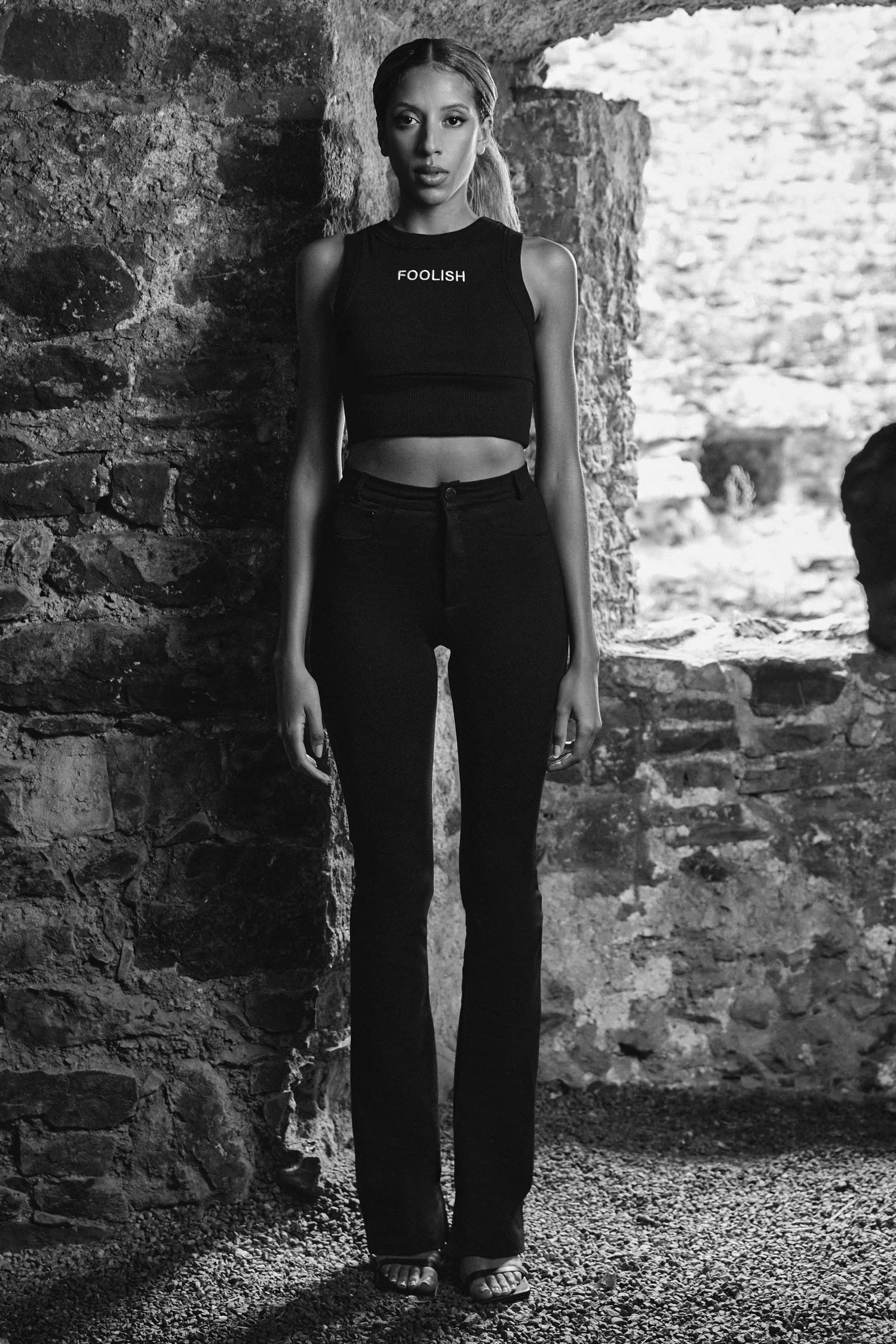 front image of womens luxury crop top in black with black pants