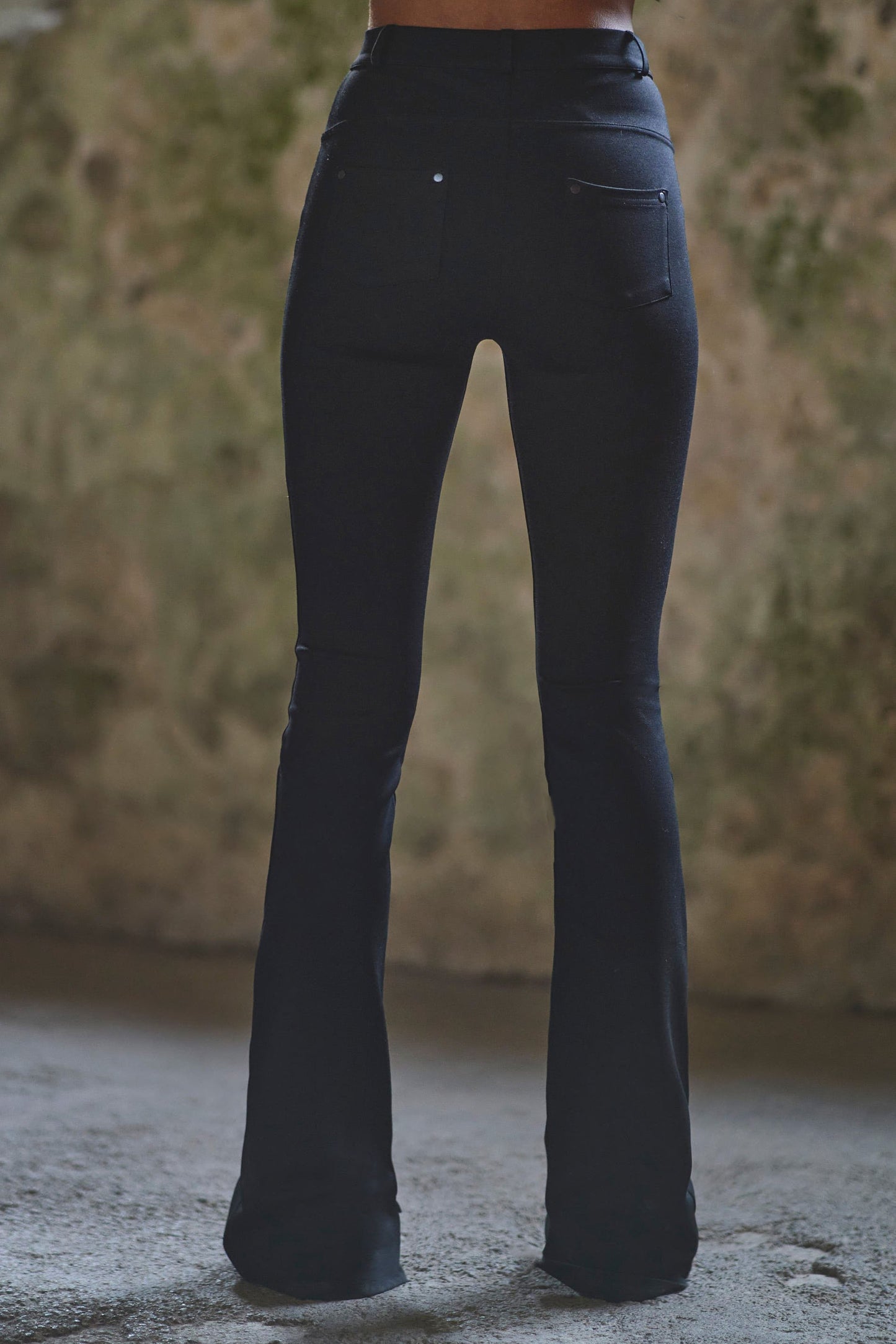 back view of womens luxury pants with flared bottom detail