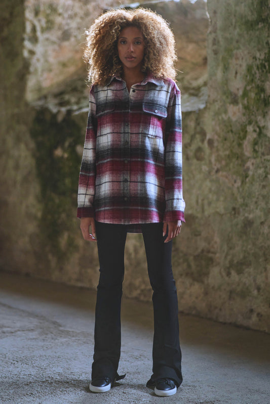 model styled in burgundy check shirt with black split hem pants