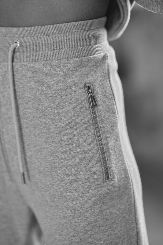 close up zip detail on womens luxury joggers in grey