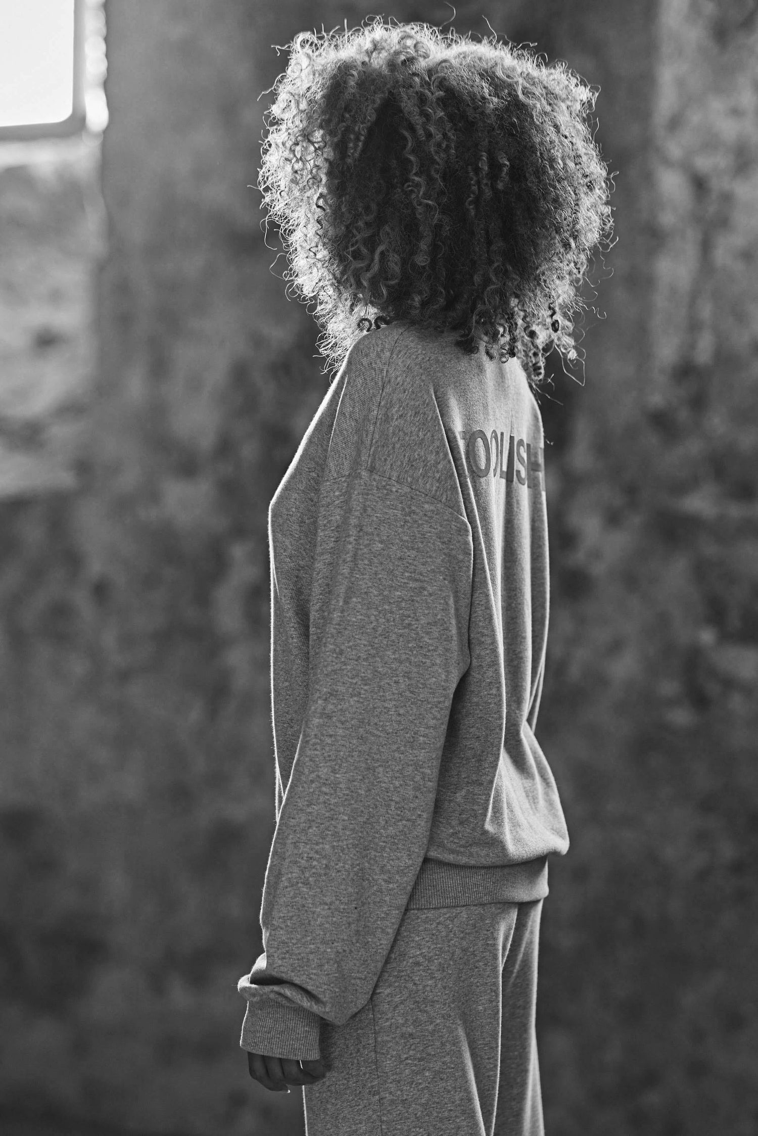 side view of model in organic grey sweatshirt and joggers