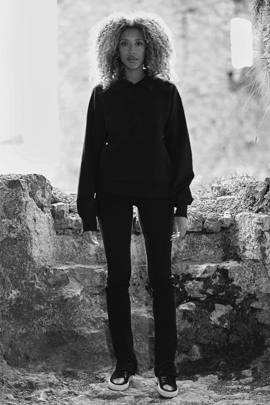 model wearing womens luxury split hem pants in black with sweatshirt