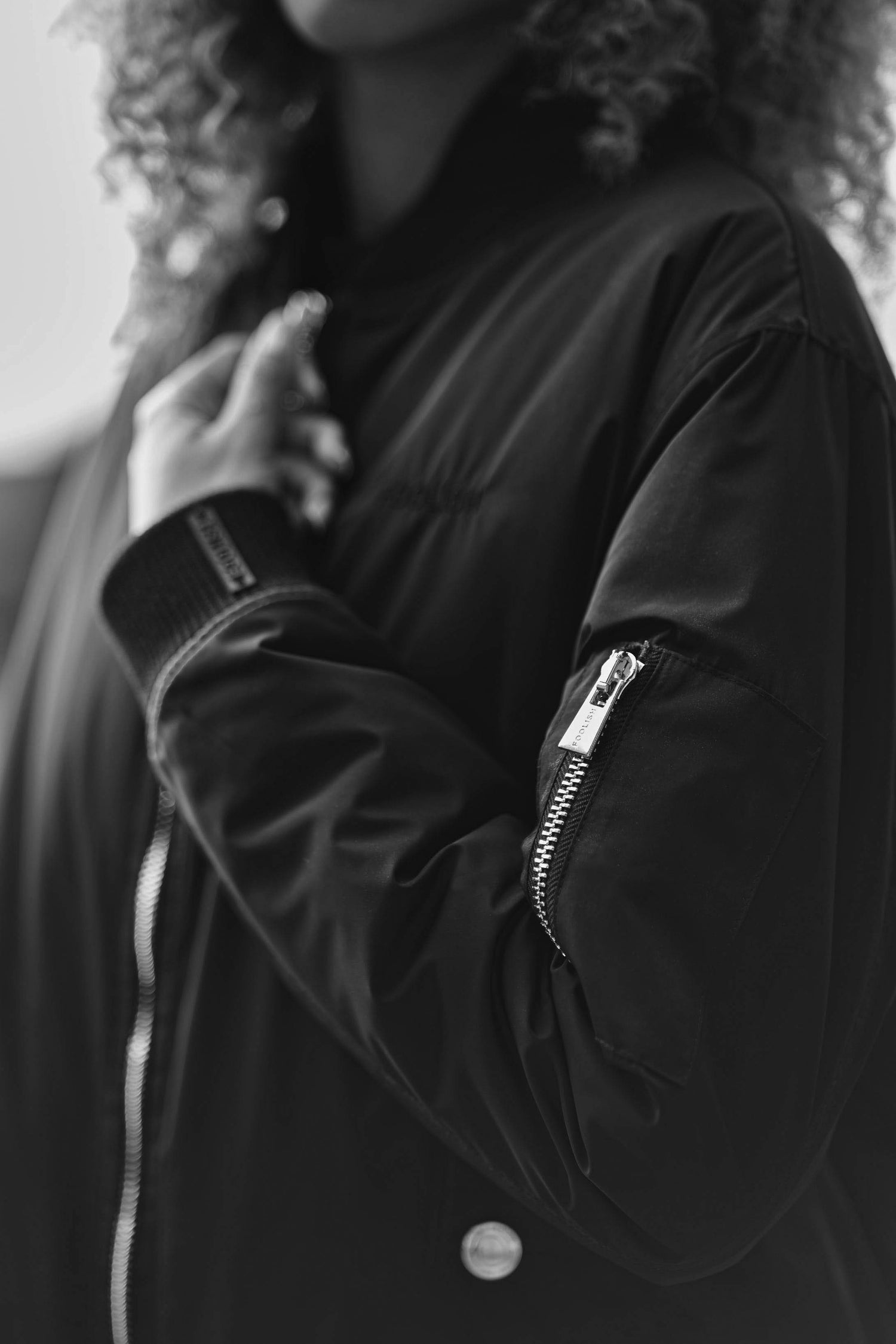 close up of zip detailing on womens luxury bomber jacket in black