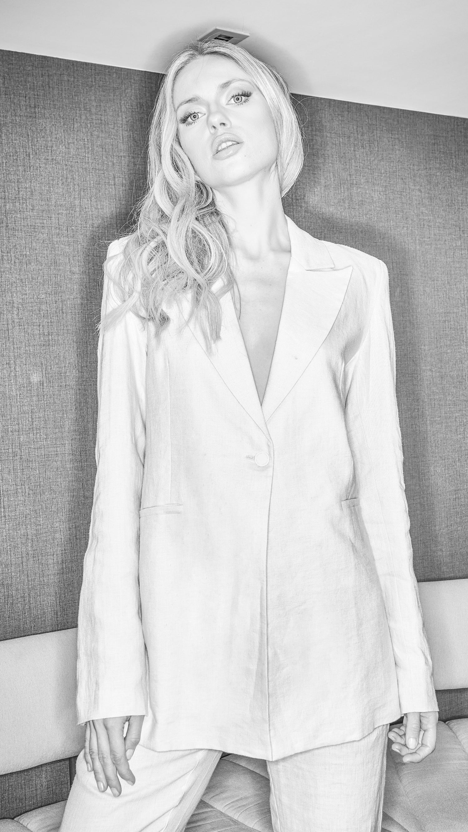 black and white image of womens luxury blazer in stone