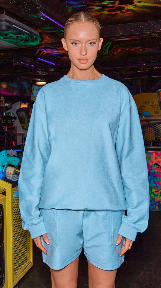 model posing in luxury womens sweatshirt in shade chalk blue